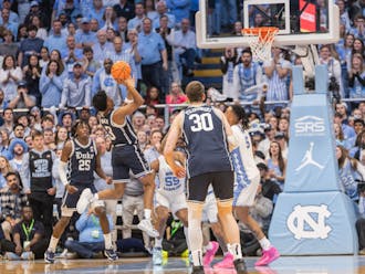 Jeremy Roach floats a shot over North Carolina defenders during the first half of Saturday's rivalry showdown.