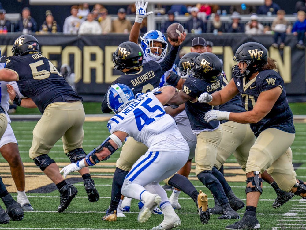 Ozzie Nicholas puts pressure on Hank Bachmeier in the backfield. 