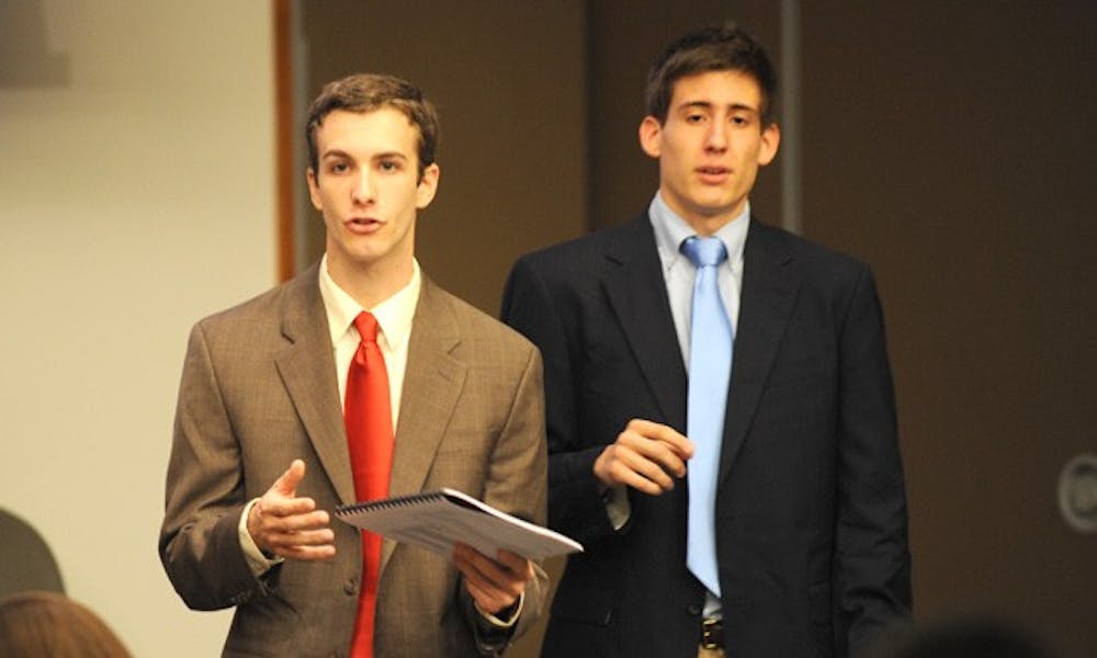 Seniors Justin Robinette, former Duke College Republicans chair, and Cliff Satell, former DCR vice chair, testify regarding DCR’s hostile atmosphere at the Duke Student Government meeting Wednesday night.