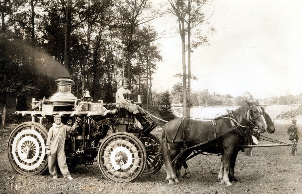 The mascot stands at left alongside a Homecoming float created by the Durham fire department in 1935.