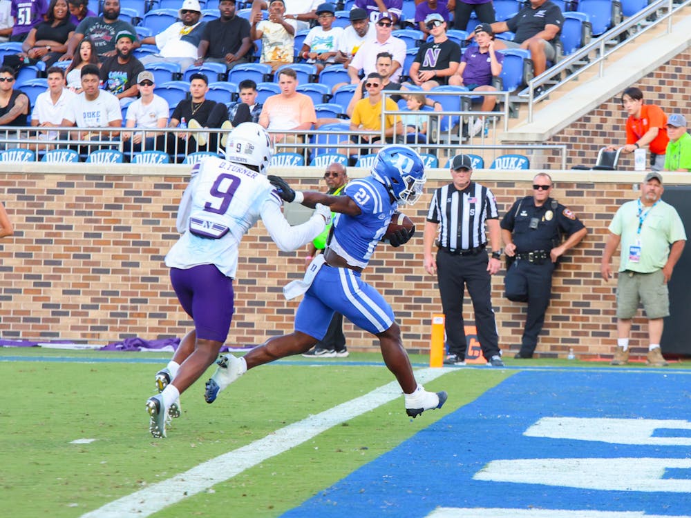 Freshman running back Peyton Jones stiff-arms a defender in the end zone during Duke's victory against Northwestern.