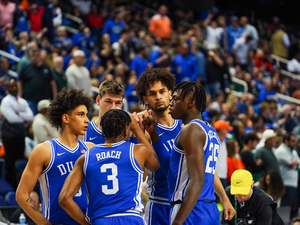 Duke's starting five huddles during Friday's semifinal win against Miami at the ACC tournament.