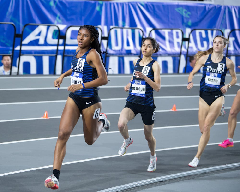 Amina Maatoug (center) paced the Blue Devils at the Nuttycombe Invitational.