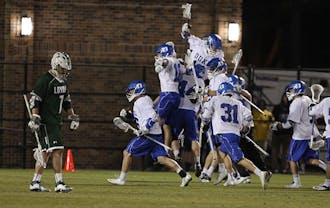 The Blue Devils celebrate after upsetting No. 4 Loyola 9-8.