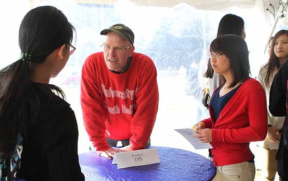 A student talks with economics professor Connel Fullenkamp at the first Academic Homecoming, a social event designed for sophomores who recently declared their majors on the Chapel Quad Wednesday.