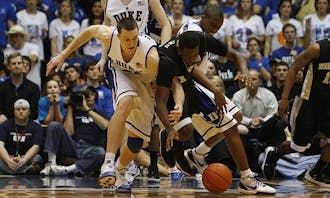 Duke’s Miles Plumlee (left) and Wake Forest’s Al-Farouq Aminu (right), the key figures of Sunday’s contest between the two ACC rivals, battle for a loose ball during the Blue Devils’ 90-70 win in Cameron Indoor Stadium.