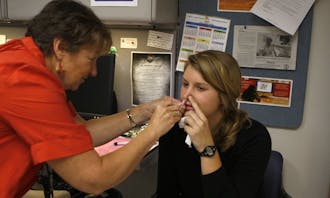 A student receives a FluMist nasal spray vaccine Tuesday at the Student Health Center. Duke received its first shipment of the vaccine last week.