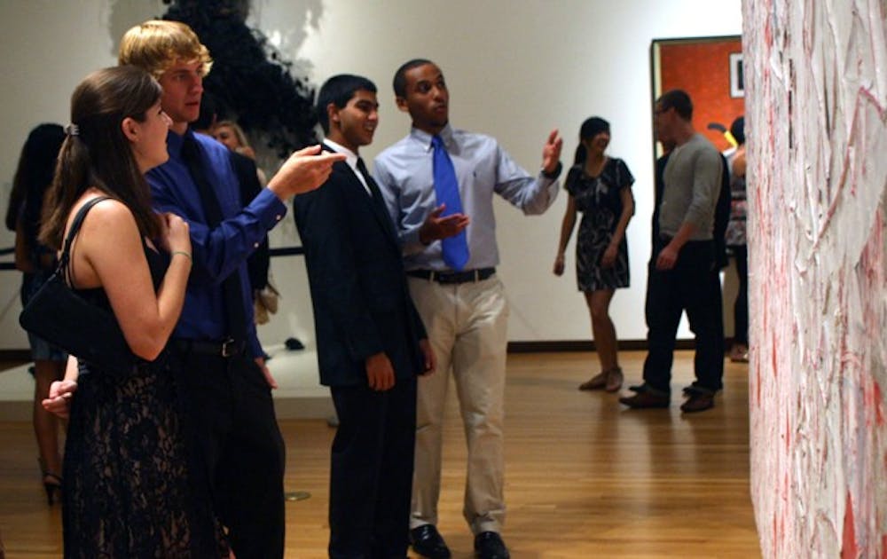 Students observe exhibits at the Night at the Nasher event held for the freshman class at the Nasher Museum of Art Saturday night.