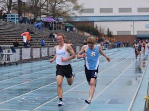 Noah Shore (right) of UNC sprints out final stretch at the Fetzer Field track.