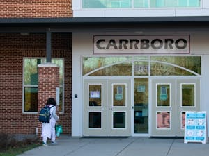A student enters Carrboro High School on Friday, Jan. 7, 2022. 