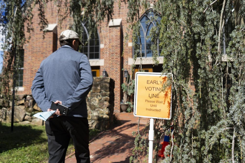 A Chapel Hill resident waits at the Early Voting line at Chapel of the Cross on Franklin Street on Thursday, Oct. 15, 2020.