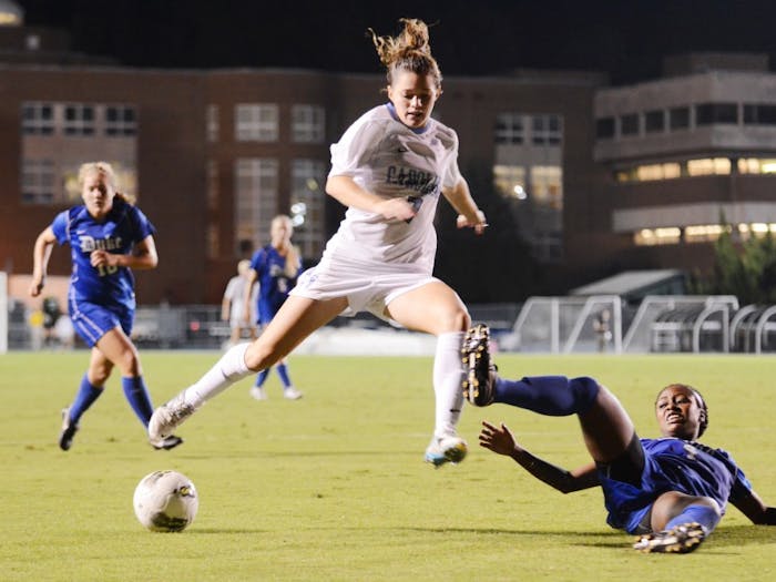 	Kealia Ohai jumps over a fallen player and dribbles down Fetzer Field. Ohai scored the winning goal against the Blue Devils in the 88th minute.