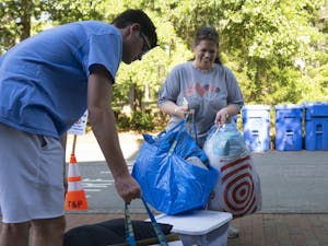 Cheryl Autry helps her son Dylan, a sophomore at UNC, move in to his on-campus dorm on Thursday, Aug. 11, 2022.