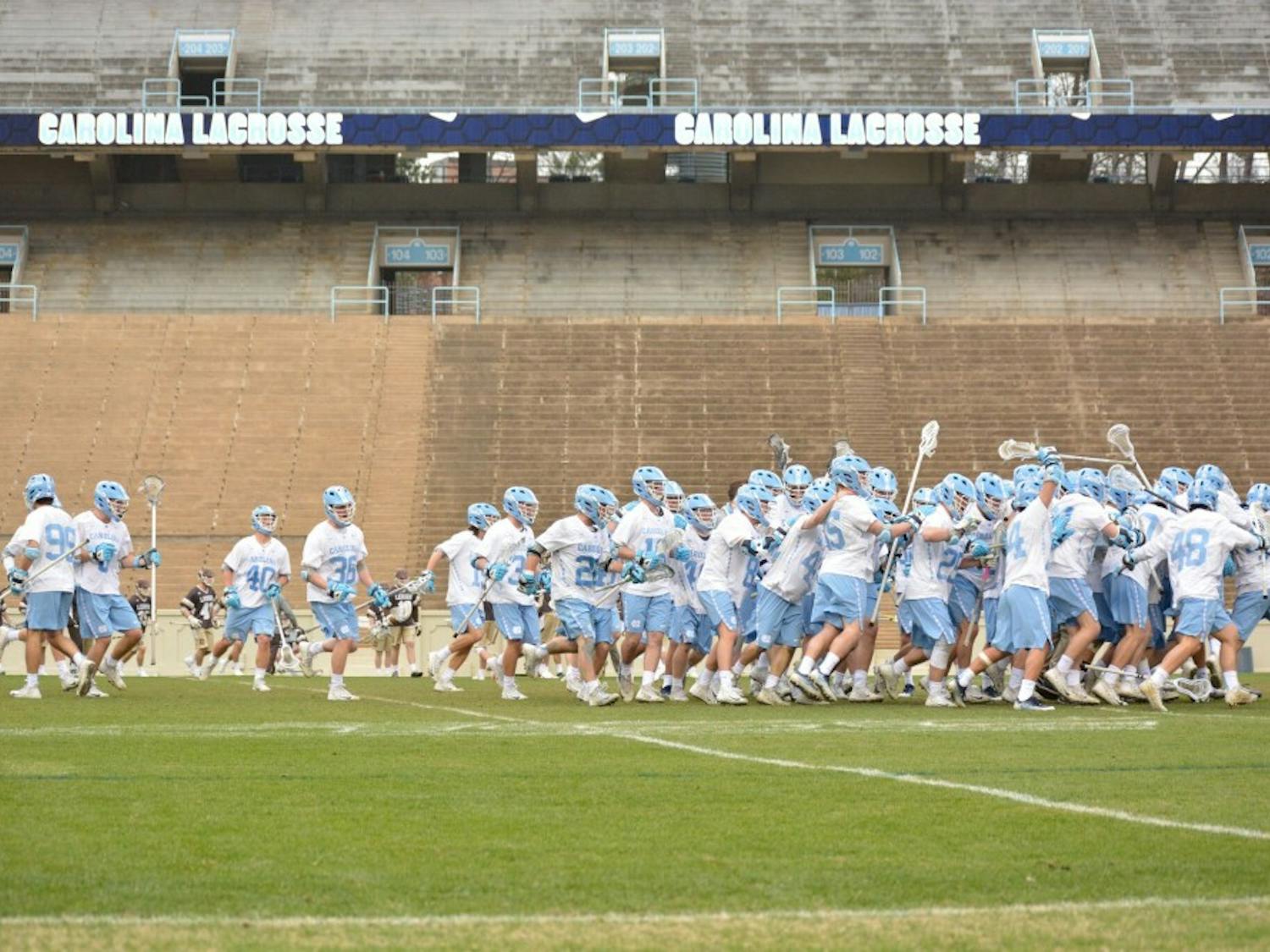 The UNC men's lacrosse team celebrates after a 12-11 overtime win against Lehigh on Feb. 17 in Kenan Stadium.