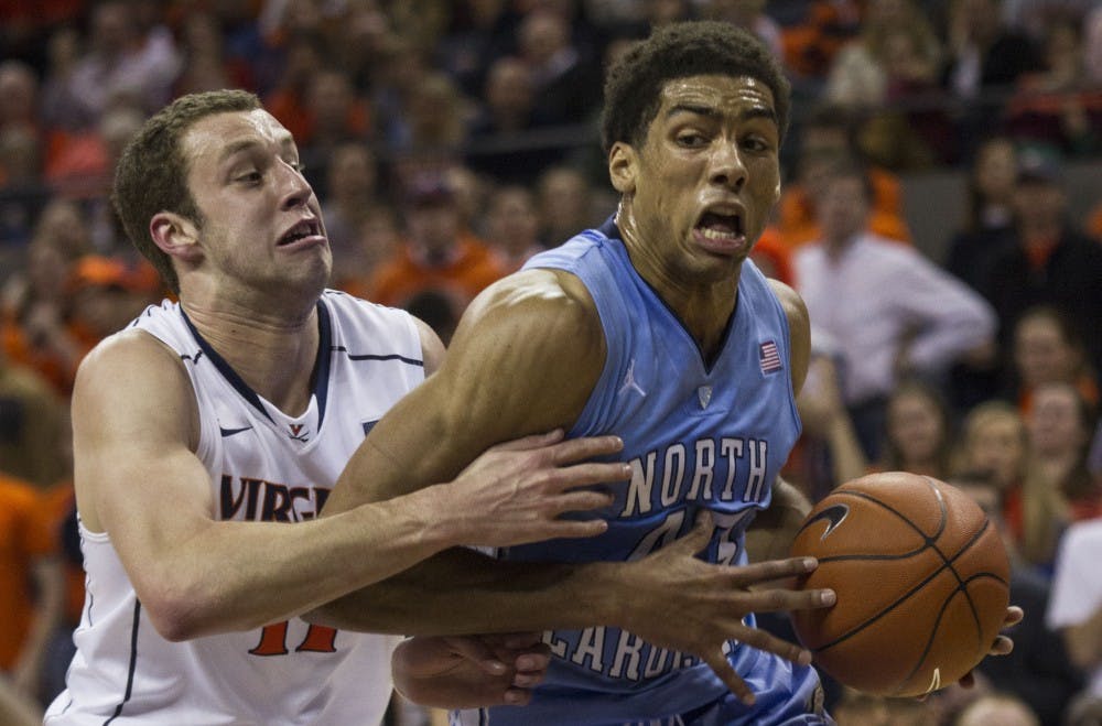 James Michael McAdoo struggles to maintain control of the ball as Evan Nolte guards.