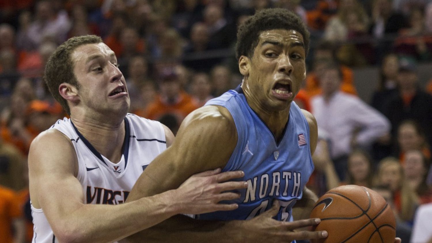 James Michael McAdoo struggles to maintain control of the ball as Evan Nolte guards.