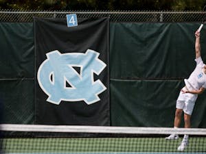 Senior Robert Kelly serves against Virginia on April 1 at the Cone-Kenfield Tennis Center.