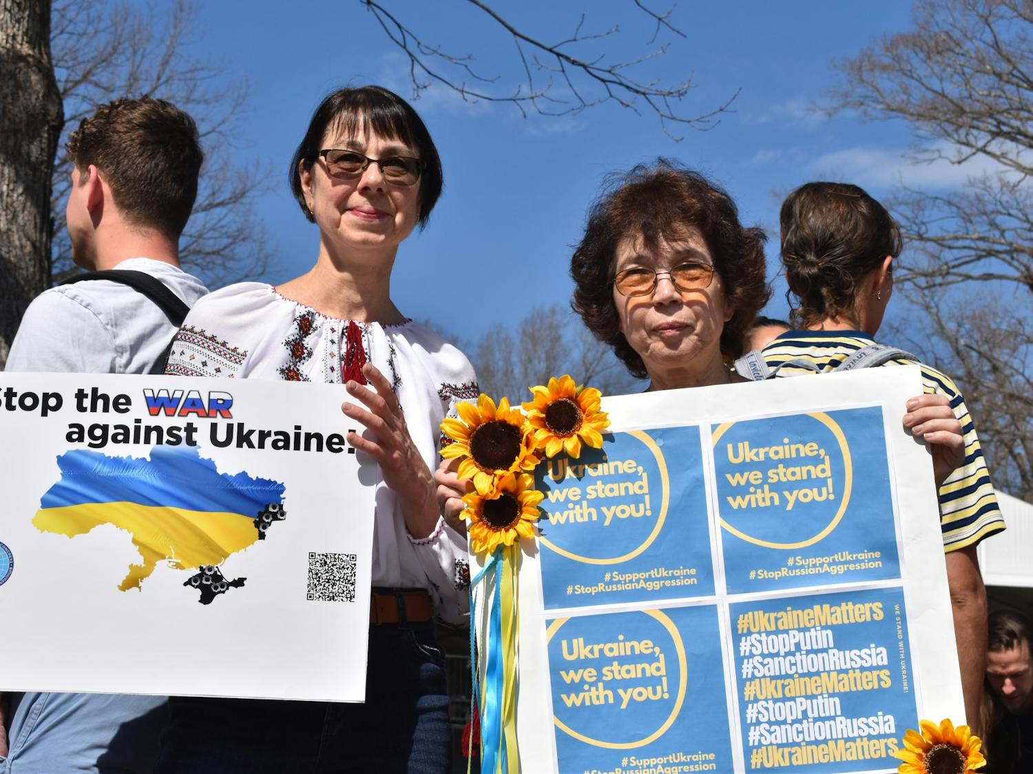 Maryana Kapustina, research associate professor at the UNC School of Medicine, and alumna Donna Goldstein hold up signs in solidarity with Ukraine at a campus rally on Thursday, Mar. 3, 2022. "We hope for a peaceful end to this war. In the meantime, support Ukraine any way you can," Goldstein said.