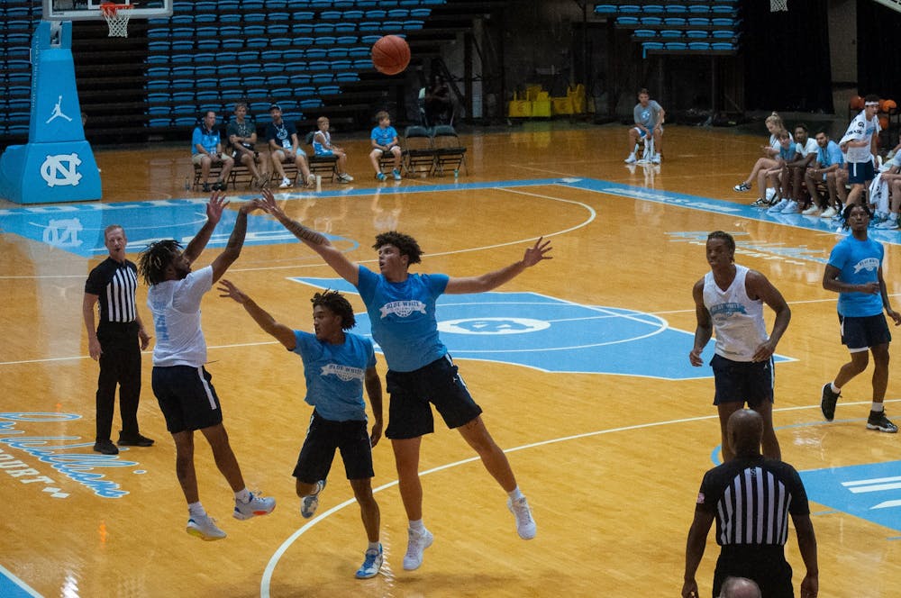 UNC junior guard RJ Davis (white) shoots a 3-pointer during the Tar Heels' preseason scrimmage on Saturday, August 27, 2022 at the Dean Smith Center.