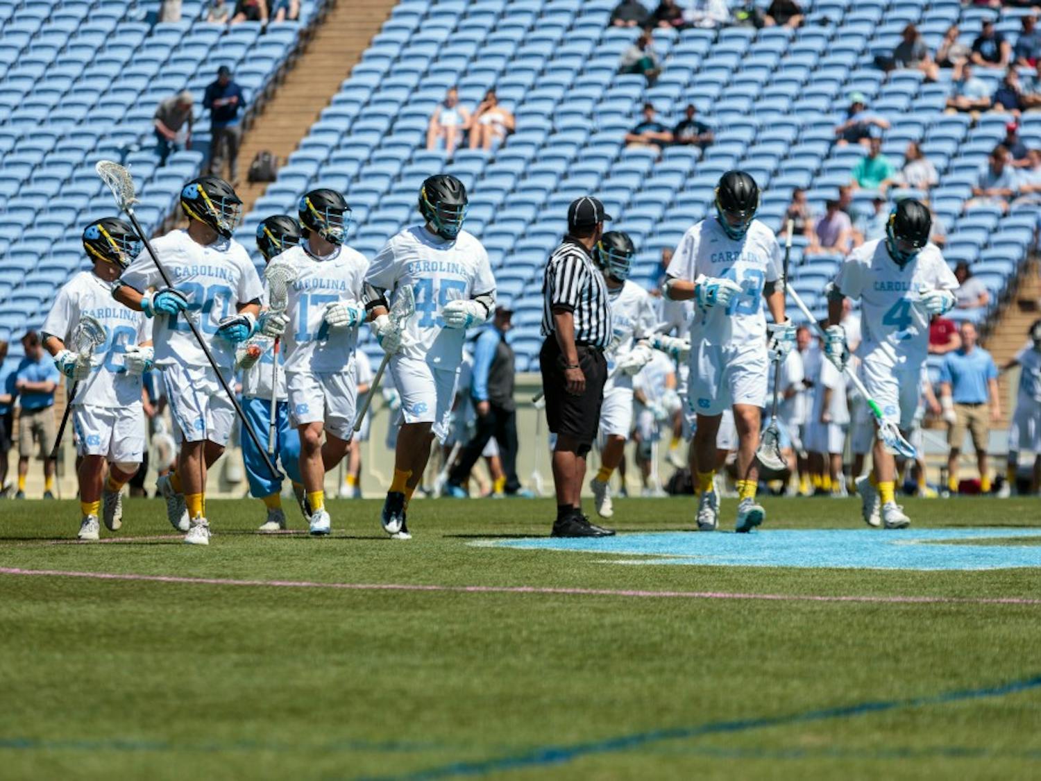 The men's lacrosse team jogs onto Kenan Stadium's field ahead of its game against Notre Dame on April 20.