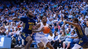UNC junior guard Caleb Love (2) protects the ball from JCSU junior guard Cartier Jernigan (12) during the exhibition game against JCSU at the Dean Smith Center on Friday, Oct. 28, 2022. UNC beat JCSU 101-40.
