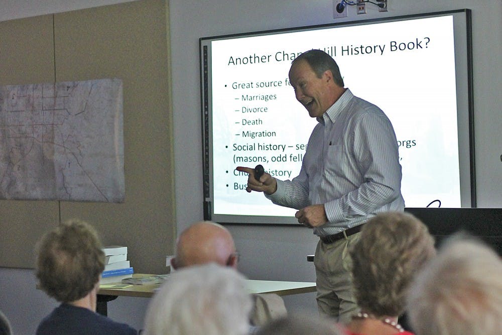 Author Stuart Dunaway presents "A Historical Overview of the Village of Chapel Hill" to a packed room in the Chapel Hill Public Library on Sunday afternoon.