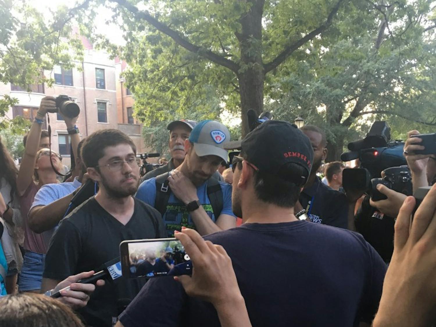 Protestors are interviewed during a rally at Silent Sam.