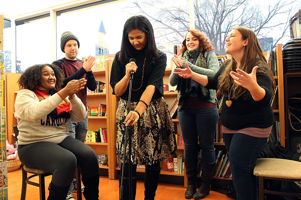 UNC Wordsmiths Mariah Monsanto, Wil Broadwell, Lauren Bullock, Polina Bastrakova, and Julia McKeown, pictured on Thursday in Bulls Head Bookshop, are getting ready for a Grand Slam on Saturday night. Bullock approaches the mic as her teammates support her.