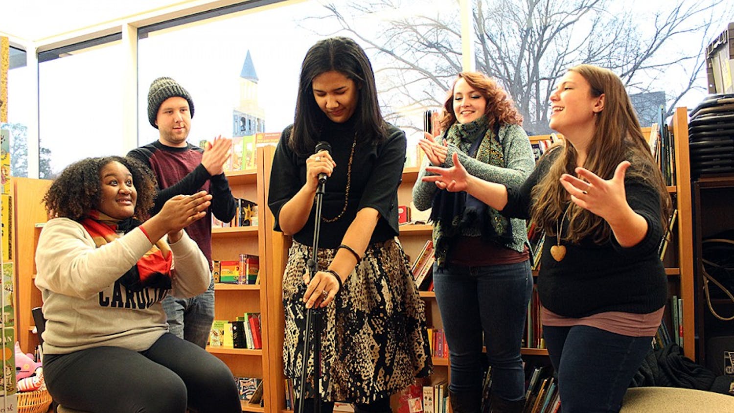 UNC Wordsmiths Mariah Monsanto, Wil Broadwell, Lauren Bullock, Polina Bastrakova, and Julia McKeown, pictured on Thursday in Bulls Head Bookshop, are getting ready for a Grand Slam on Saturday night. Bullock approaches the mic as her teammates support her.