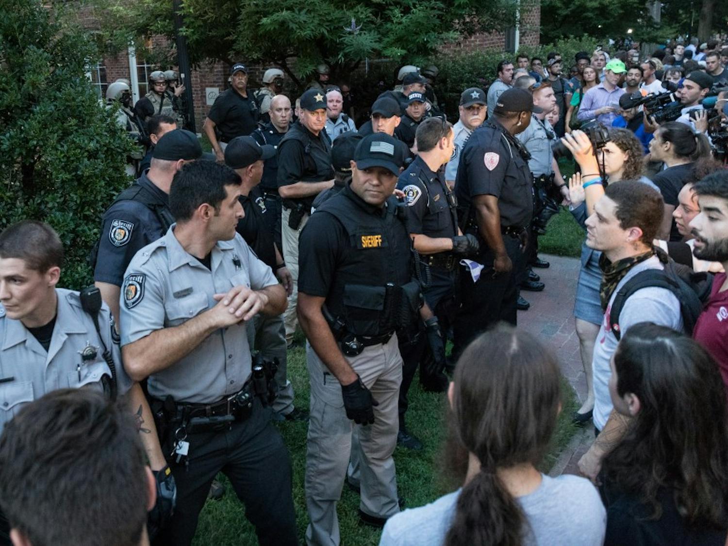 Police formed a barricade to hold off protestors around Hyde Hall after detaining a man during a protest in August.