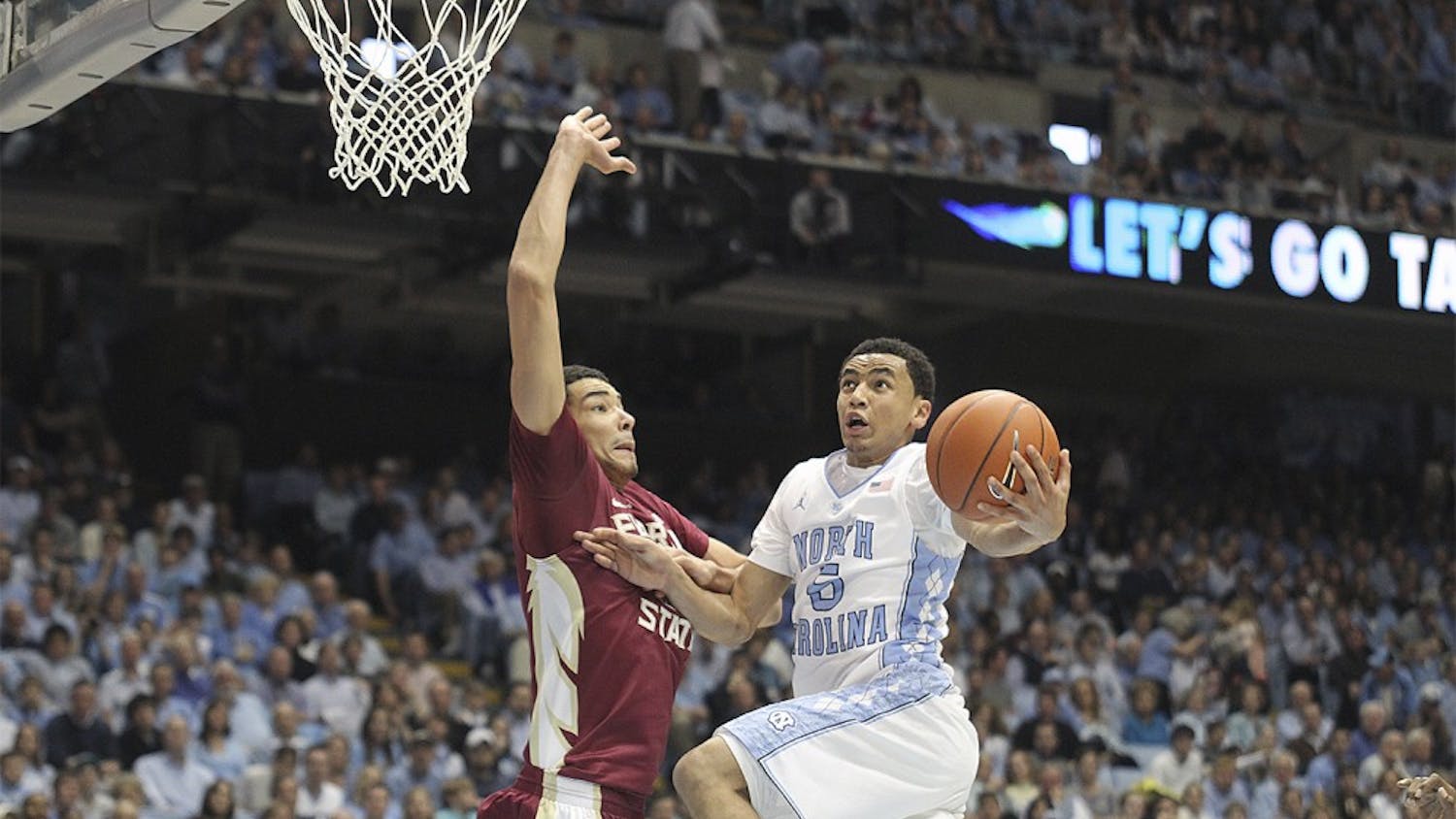 Junior point guard Marcus Paige goes up for a layup against a Florida State defender in a game on Feb. 17, 2014.