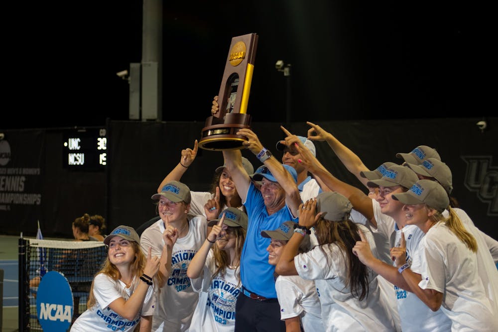 <p>The UNC women's tennis team poses with their trophy after winning the NCAA Tournament on May 20, 2023.&nbsp;</p>