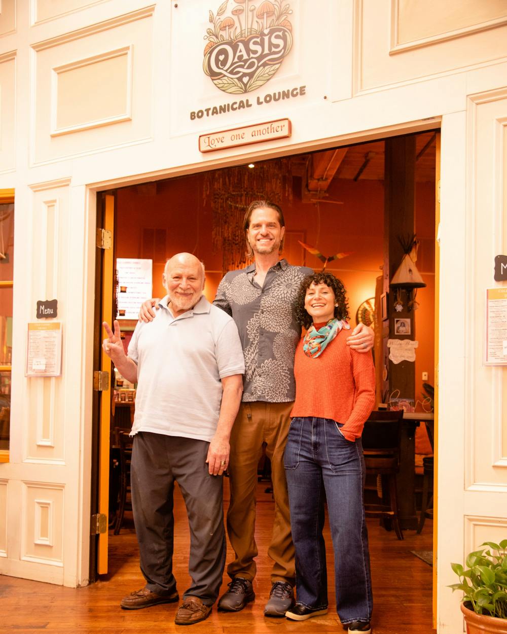 <p>Robert Roskind, James Dearing and Alicia Roskind Dearing pose at the entrance of the Oasis Botanical Lounge<br>
Photo Credit: Michael McClellan</p>