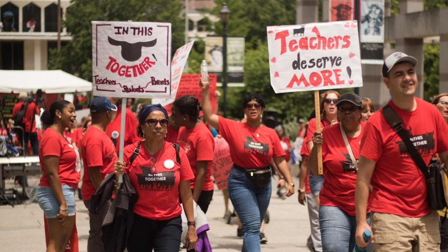 Educators carry signs through Bicentennial Plaza during the rally for education on May 16 in Raleigh.