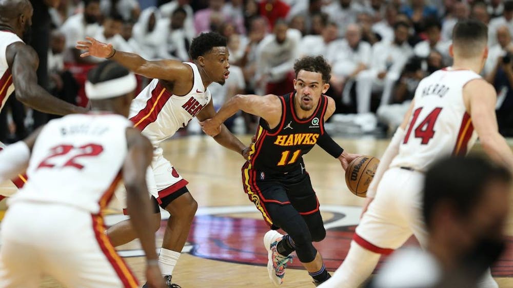 Atlanta Hawks guard Trae Young (11) drives the ball as Miami Heat guard Kyle Lowry (7) defends in the first quarter at FTX Arena in Miami on Sunday, April 17, 2022. Photo courtesy of TNS.