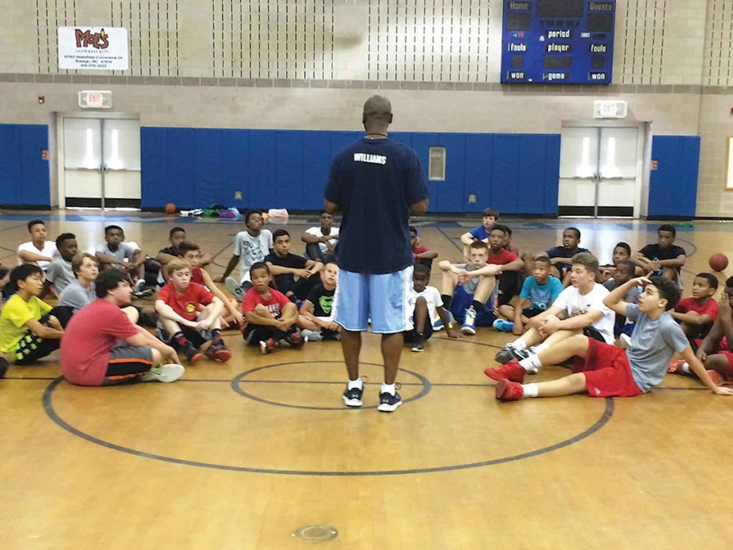 Donald Williams, a former NCAA National Championship winner, hosts a summer basketball camp for children in the community.