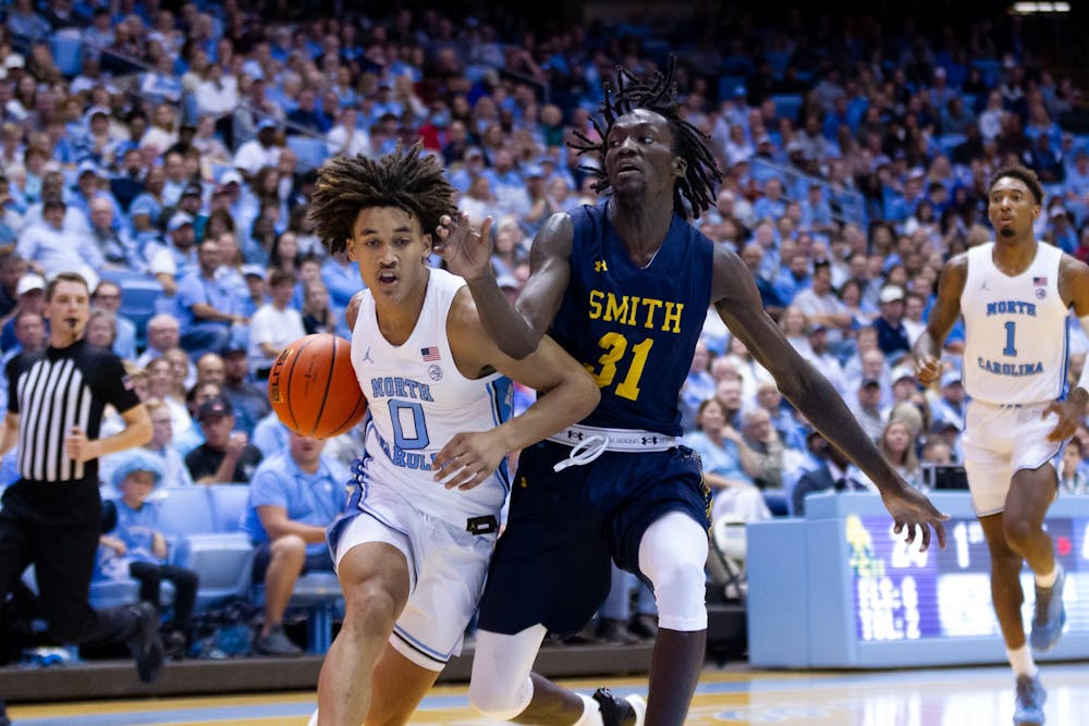 <p>UNC freshman guard Seth Trimble (0) defends the ball during the basketball game against JCSU on Friday, Oct. 8, 2022. UNC beat JCSU 101-40.</p>