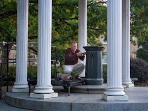 David Catalano from UNC Environmental, Health and Safety collects water samples from the Old Well to test for lead exposure on Thursday, Oct. 20, 2022. Multiple water fountains at UNC have been found to contain unsafe levels of lead.