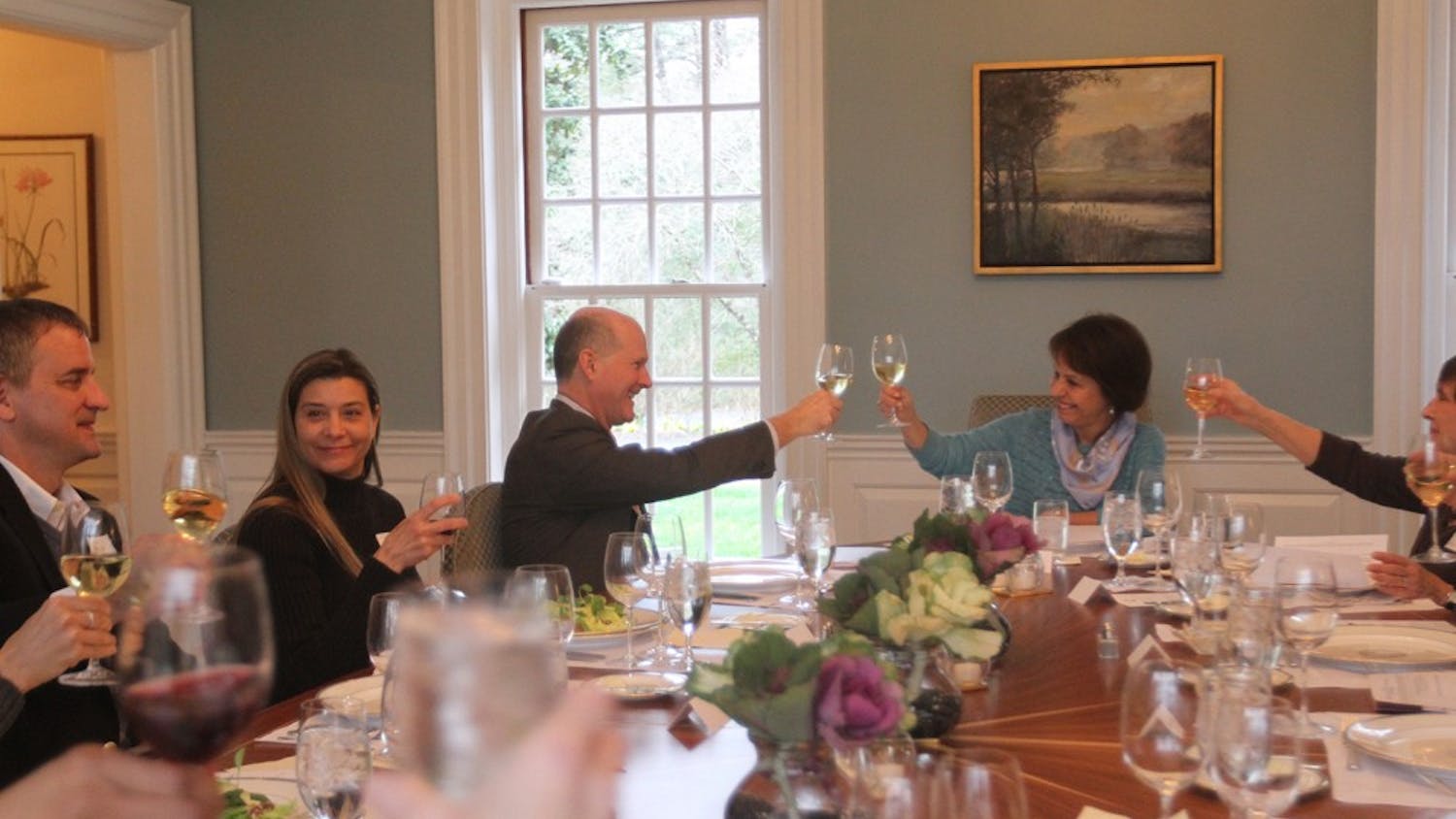 The Faculty Athletics Committee toasts before a meeting at Chancellor Folt's house on Wednesday night.