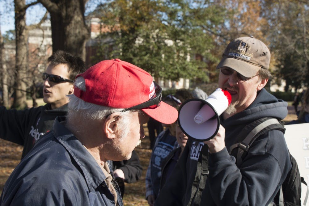 A counter protestor shouts at a supporter of Silent Sam through a megaphone during a confrontation in McCorkle Place.
