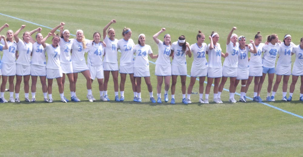 Members of the women's lacrosse team celebrate after a victory against Penn State Saturday afternoon.