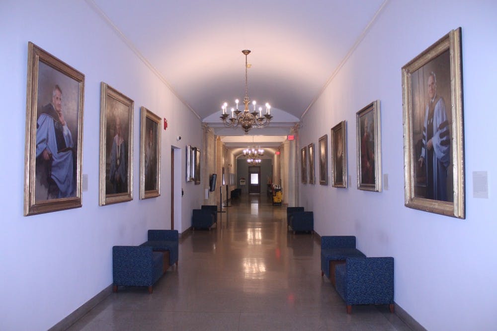 <p>Portraits of former UNC chancellors line the walls of Wilson Library on the campus of the University of North Carolina at Chapel Hill.&nbsp;</p>