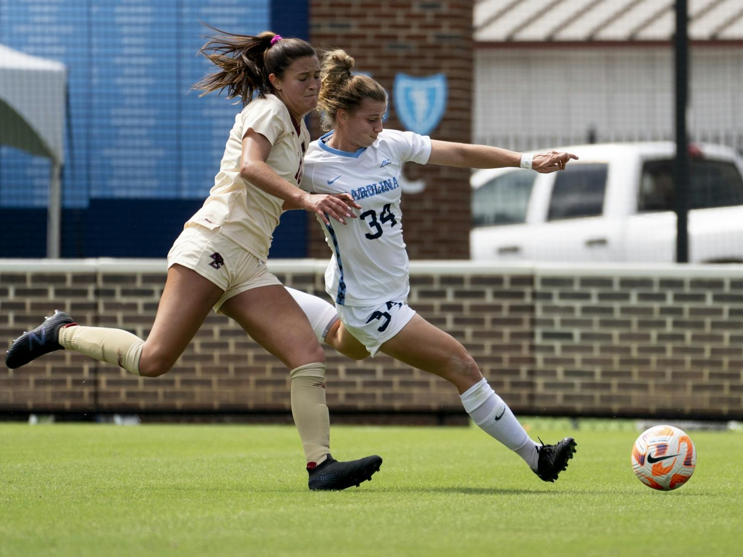 First-year forward Tessa Dellarose (34) races a Boston College player for the ball at the UNC women’s soccer game against Boston College at Dorrance Field on Sunday, Sept. 25, 2022. UNC won 3-0.