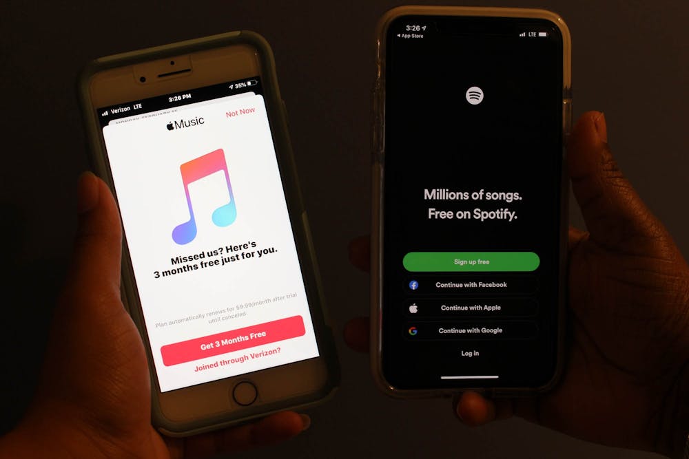 DTH Photo Illustration. There has been a long standing debate of which music streaming platform is the best: Spotify or Apple Music. Students tell us the pros and cons of each service and which they like best.