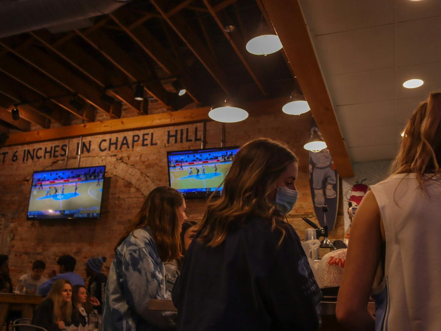 Students gather in Sup Dogs on Franklin Street to watch UNC's 91-73 defeat of Duke basketball on March 6, 2021.