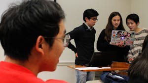 (From left to right) Political committee member Daniel Kang, President Anna Hattle and Senior Advisor Jessie Huang of the Asian American Student Association prepare to address the members of the organization in Bingham Hall on Thursday, Feb. 28, 2019.