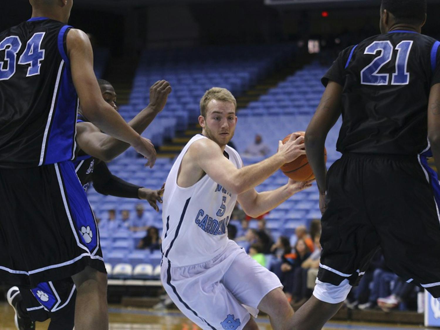 Harrison Lancaster (5) swerves between Central Carolina Community College players Saturday afternoon at the Dean Smith Center. 