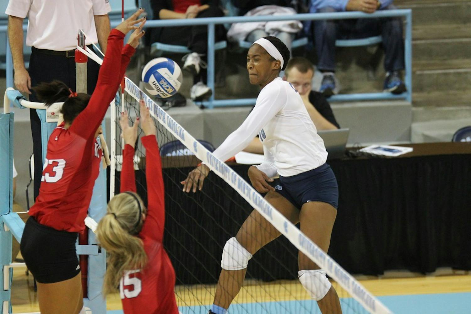 Senior opposite hitter Chaniel Nelson spikes the ball over NC State players and helped contribute to the Heels' .351 team hitting percentage.