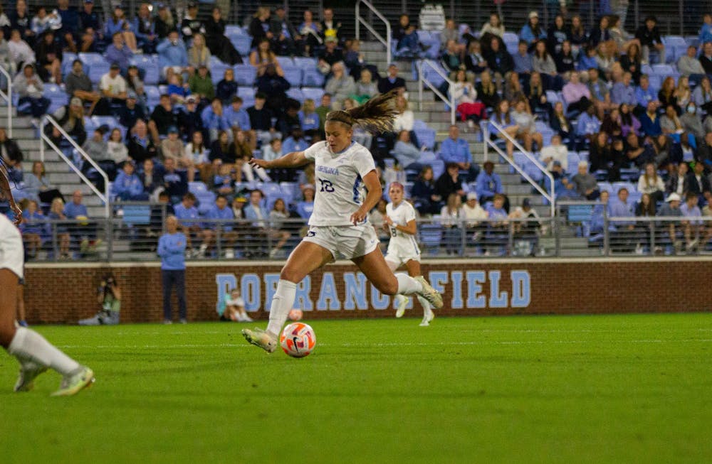 Sophomore midfielder Bella Sember (18) passes the ball downfield during the women's soccer game against Wake Forest on Friday, Oct. 14, 2022, at Dorrance Field. UNC beat Wake Forest 1-0.