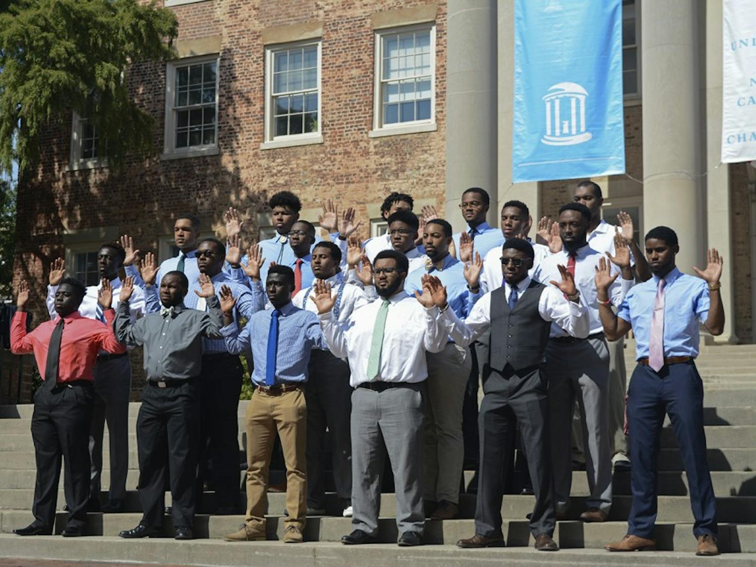 UNC students gathered in front of South Building to take the 100 Black Men in Suits Challenge. It is a challenge that's been taken on at colleges across the country to give a new image to black men. The men pose in suits for a photo to fight stereotypes of black men. 